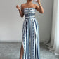 👗 NU 50% KORTING! 💥 Geometrische jumpsuit met halterhals en zijsplit – Unieke print en elastische achterkant – Veelzijdig, perfect voor zomerfeestjes of als resortkleding ✨